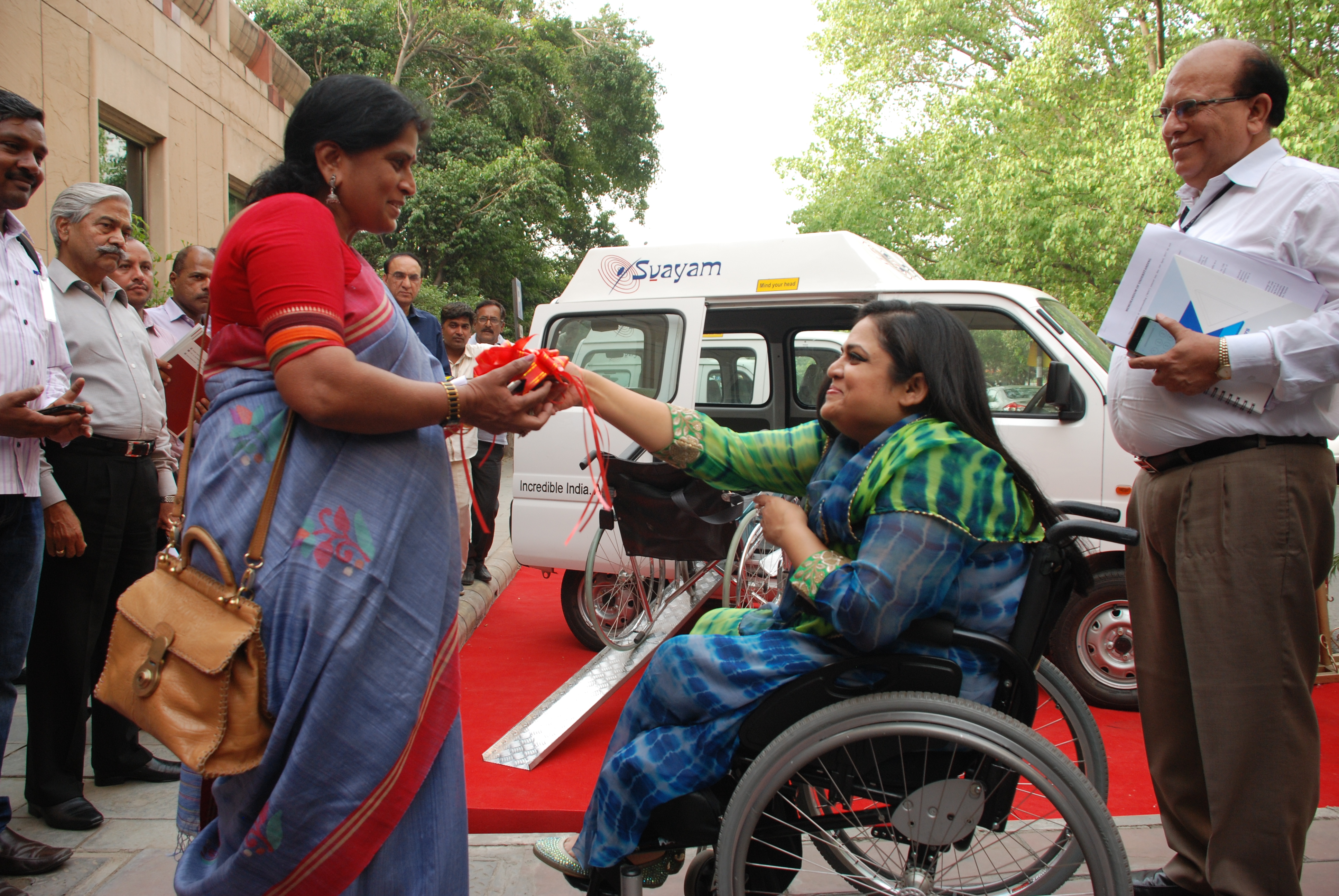 Ms. Albina Sarkar, Director Mobility India receiving the keys from the Ms. Sminu Jindal, Founder Svayam